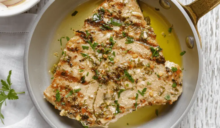 Juicy chicken breasts soaking in the aromatic Lemon Herb Marinade, prepping for a flavorful roast.