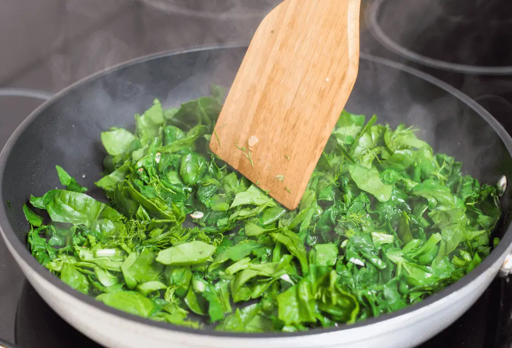 Spinach wilting for the Creamy Tuscan Sausage Pasta dish.