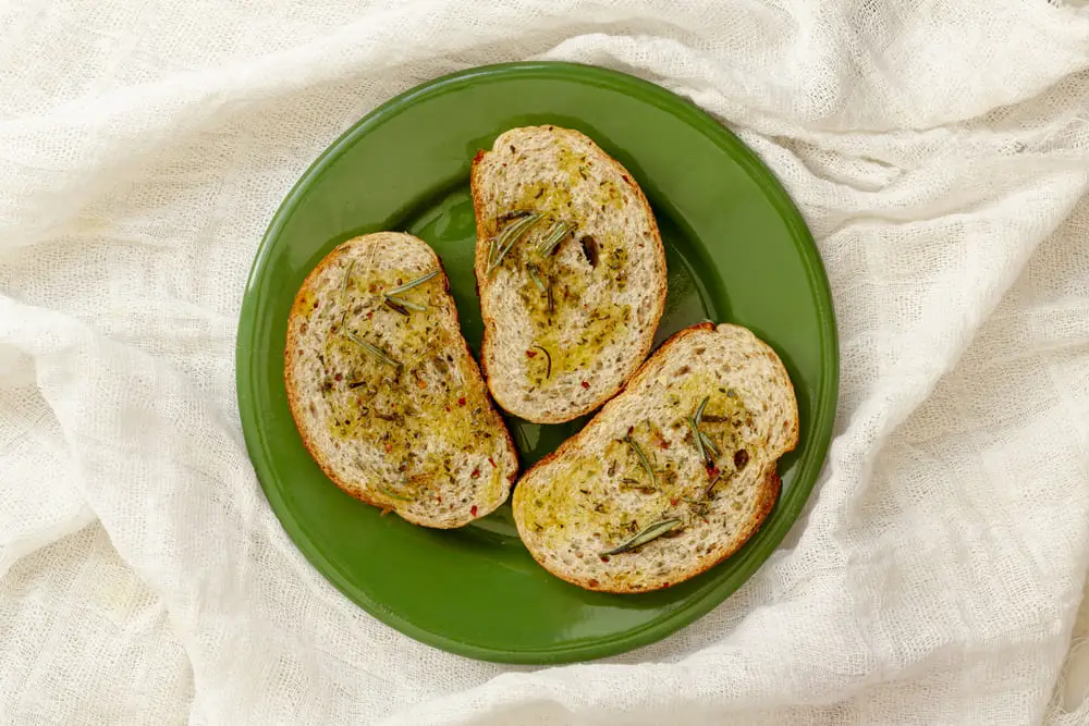 Grilled bread slices brushed with olive oil, ready for Italian Bruschetta topping.