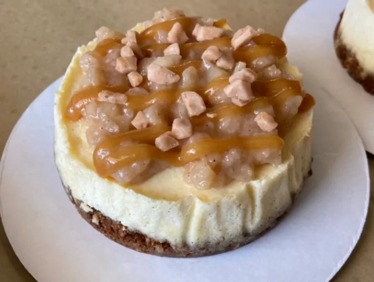 Mini Caramel Apple Cheesecakes with a gingersnap crust, topped with streusel and drizzled caramel.