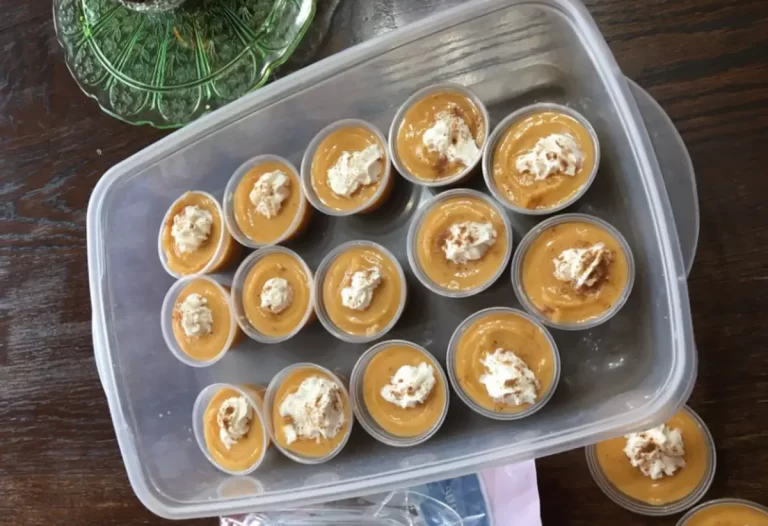 Delicious pumpkin pudding shots lined up with whipped cream on top, ready to be enjoyed with family!