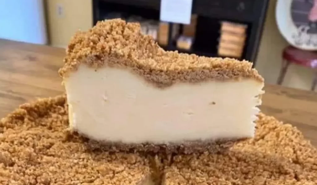 A delectable slice of Double Crust Cheesecake, showcasing a creamy cheesecake layer sandwiched between two golden, buttery graham cracker crusts.