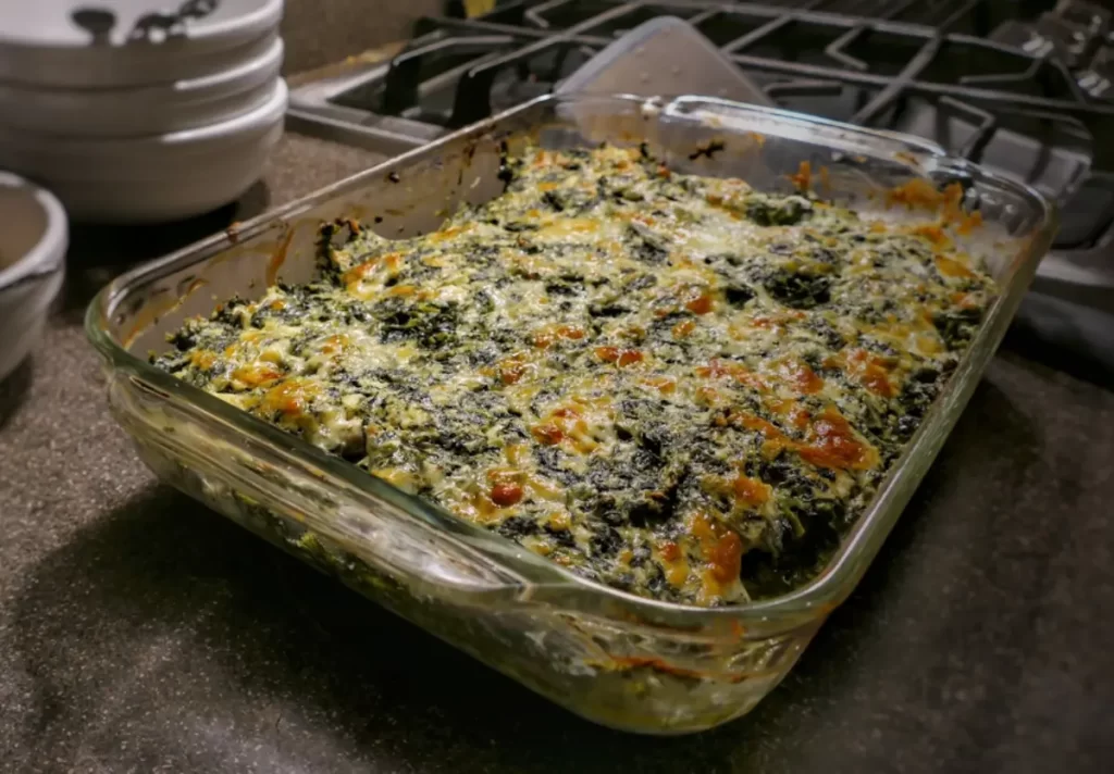 A delicious Spinach and Feta Casserole made with creamy cottage cheese, tangy feta, and nutritious spinach, served in a casserole dish.