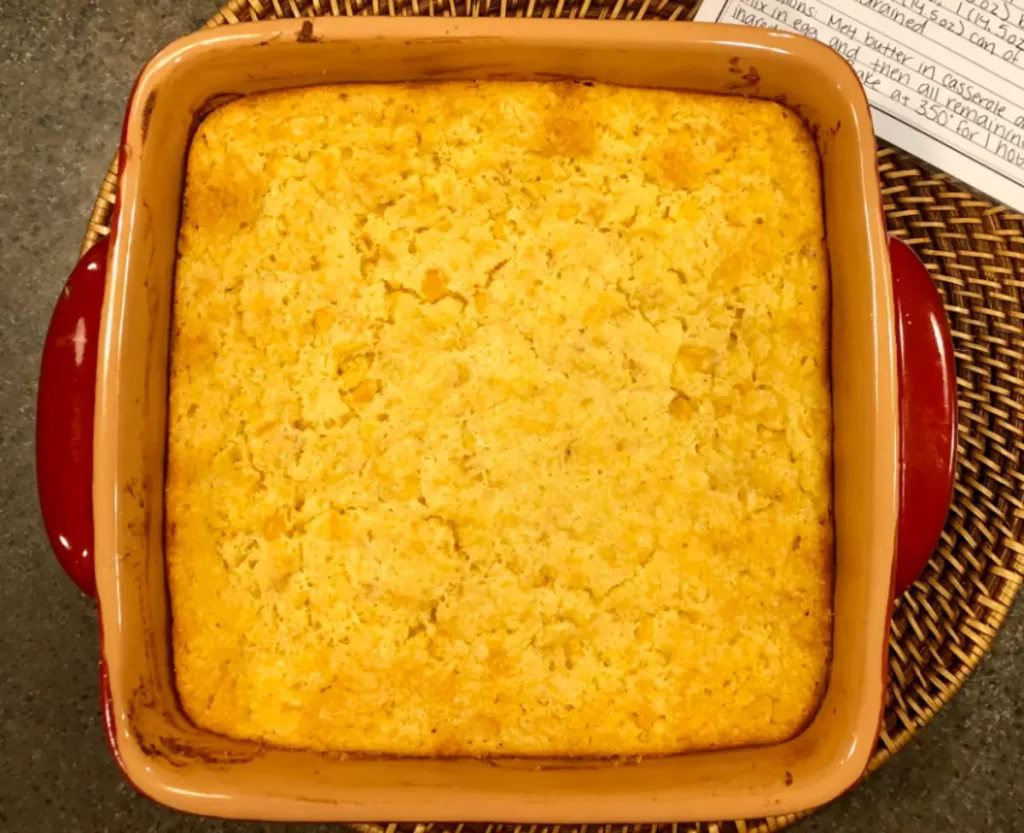 A comforting dish of Jiffy Corn Pudding served in a baking dish, showcasing its creamy texture and golden-brown crust.