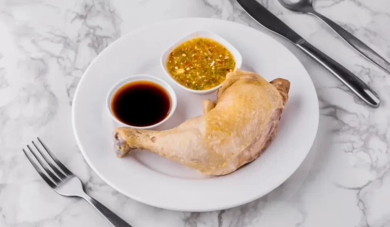 A succulent boiled chicken thigh elegantly served on a plate, ready to be enjoyed.