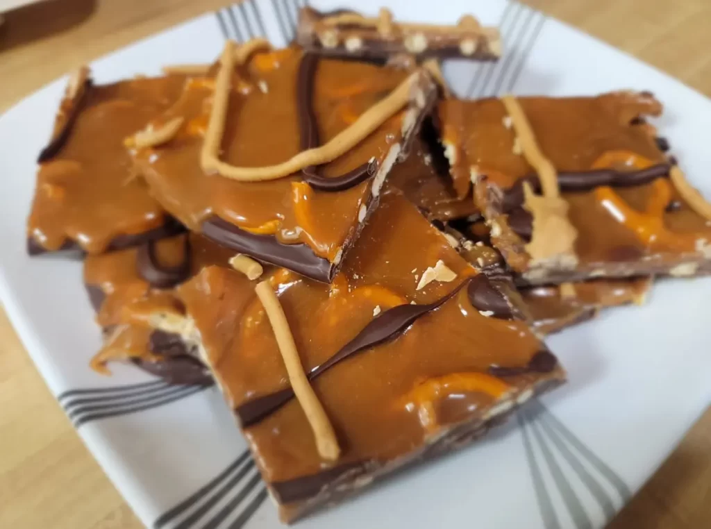 A tempting stack of No-Bake Caramel Pretzel Crack Bars showcasing layers of chocolate, caramel, and pretzels.