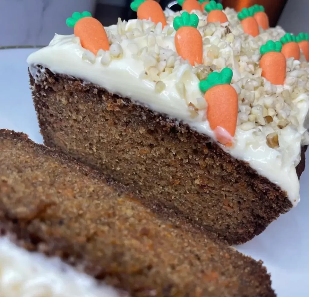 A freshly baked Carrot Cake Loaf, moist and flavored with cinnamon, ginger, and nutmeg, topped with optional cream cheese frosting.