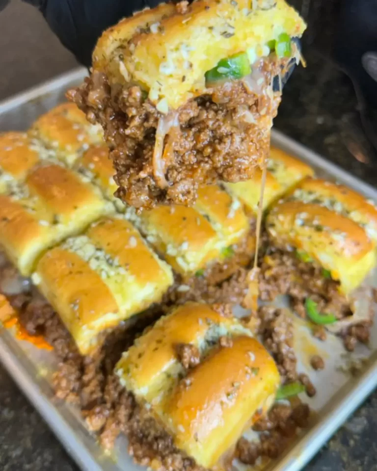 Homemade Cheesy Beef Sliders on Hawaiian rolls with a buttery topping.