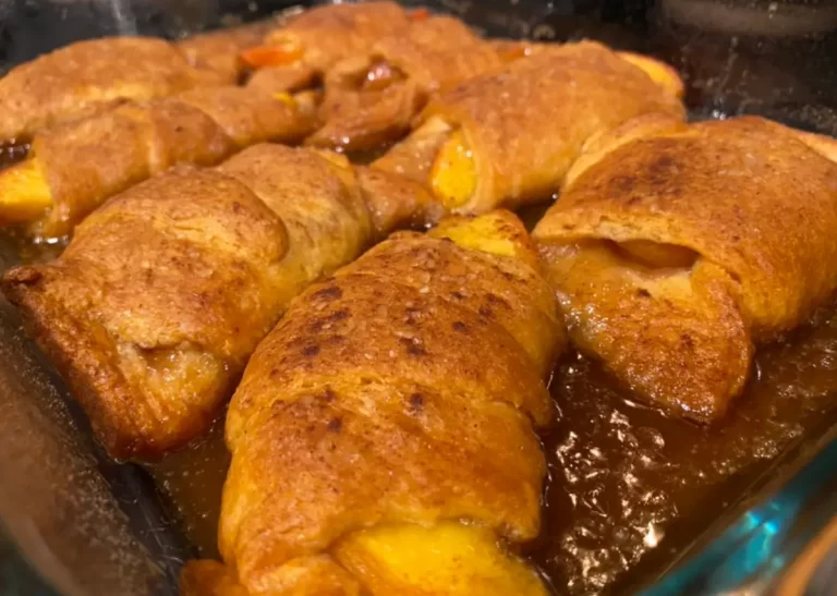 Warm peach dumplings baked to perfection with a glistening cinnamon-sugar crust.