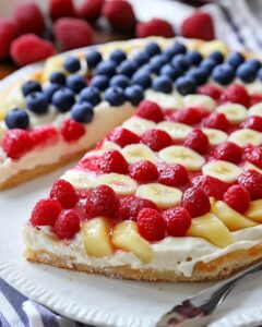 Create a delicious American Flag Fruit Pizza that's perfect for summer gatherings or the 4th of July! This colorful dessert combines a soft sugar cookie crust with cream cheese frosting and a variety of fresh fruits, making it a delightful and refreshing treat. Packed with vitamins, it’s a fun way to enjoy fruits while celebrating! Save this pin and try the recipe for a festive addition to your next celebration!