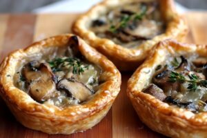 Indulge in these delicious Mushroom, Shallot and Herbed Goat Cheese Tarts! Perfectly flaky and packed with savory flavors, these tarts make a great appetizer or light meal. Enjoy the rich taste of mushrooms combined with creamy goat cheese and aromatic shallots. Try this recipe for an impressive dish that’s easy to create! Save this pin and get cooking today!